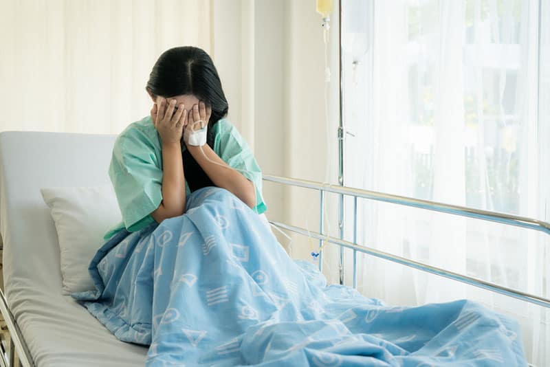 sad woman crying on the hospital bed