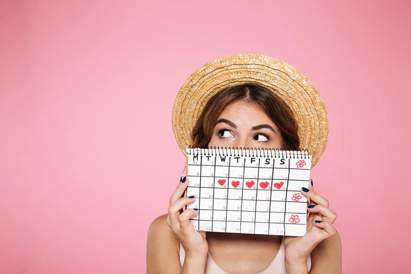 woman holding period calendar