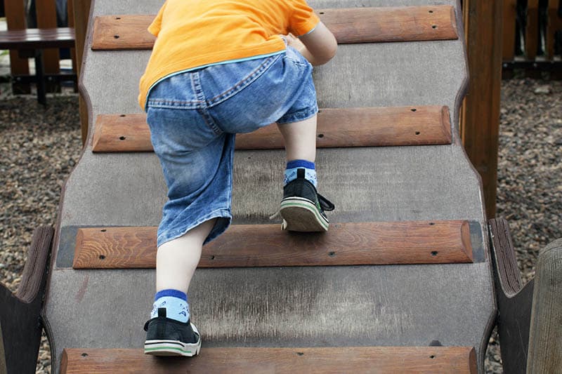 young kid toddle climbing developing gross motor skills