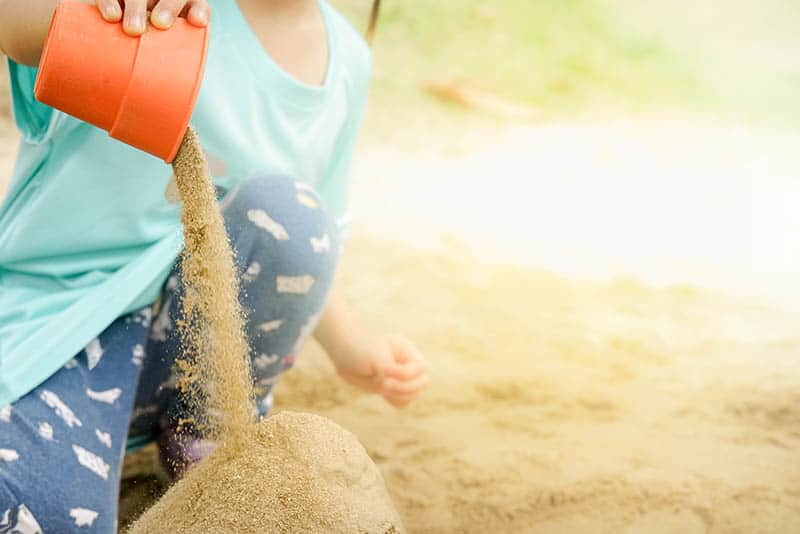 kid toddler playing in sand