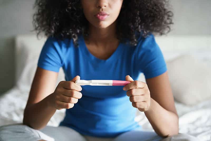 woman holding a pregnancy test 