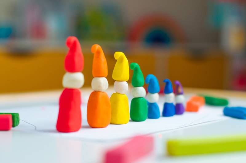 colorful figures made of clay on wooden table