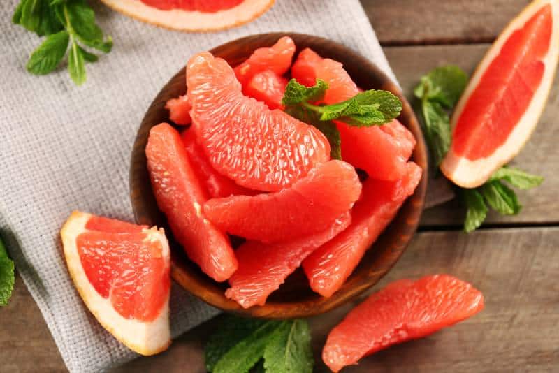 Juicy grapefruit pieces with fresh mint in a bowl