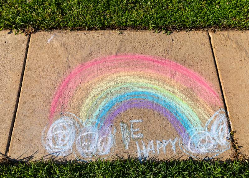 The words "Be Happy" written with sidewalk chalk