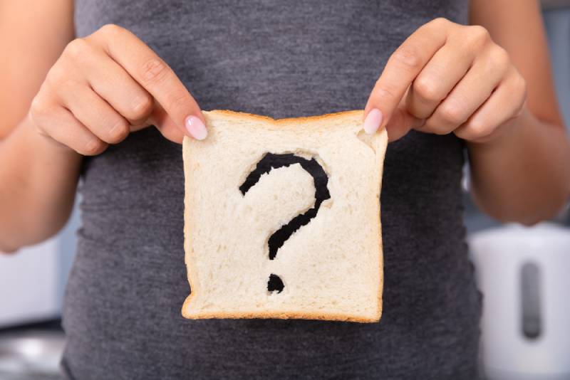 Woman Hands Holding Sliced Bread With Question Mark Sign