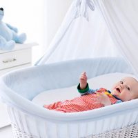 baby lying in bassinet