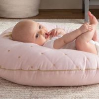 baby lying in pink lounger