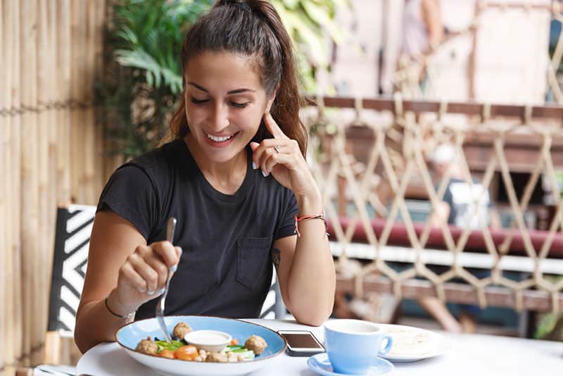 young smiling woman eating