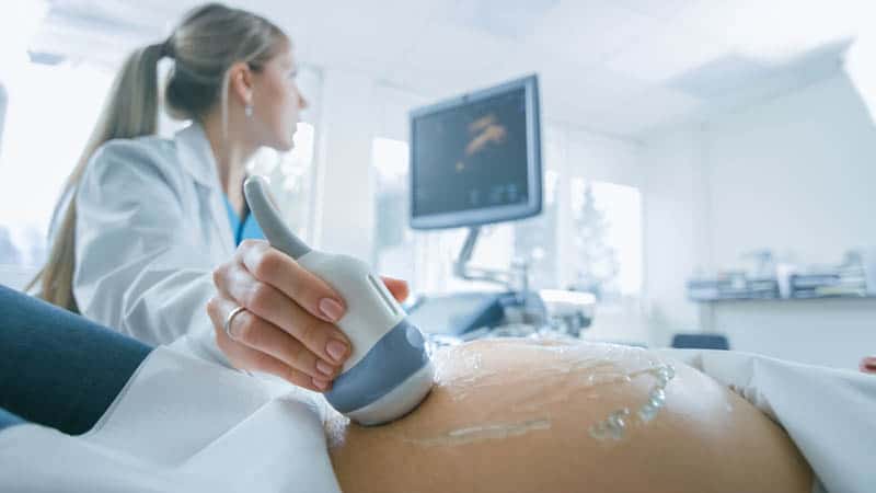 doctor doing ultrasound to pregnant woman