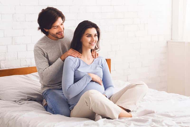 husband giving massage to his pregnant wife