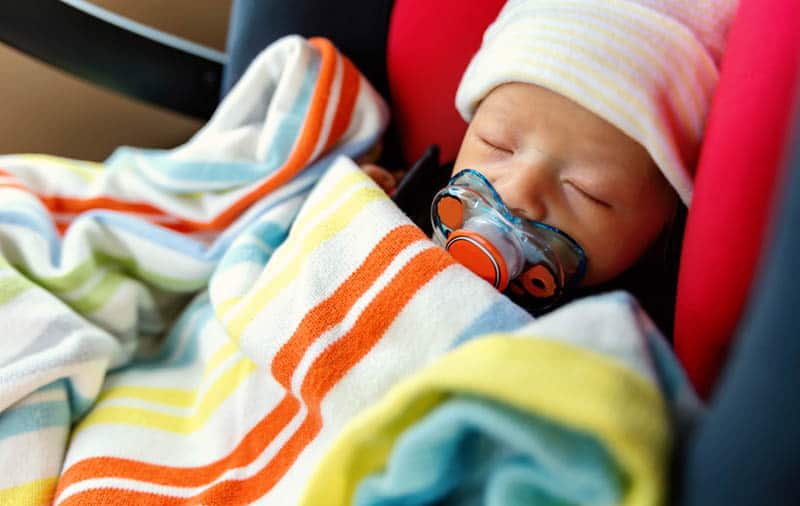 newborn baby sleeping covered with blanket