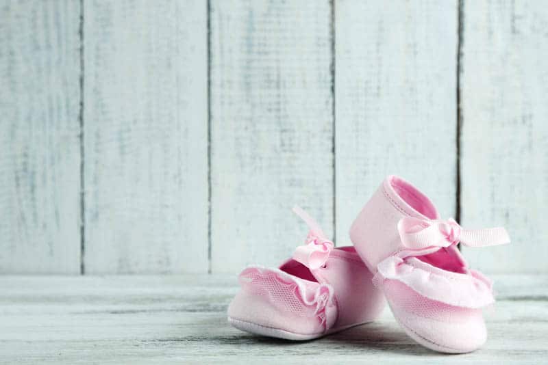 pink toddlers shoes on wooden background