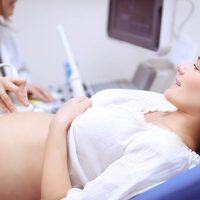 pregnant woman doing ultrasound with doctor
