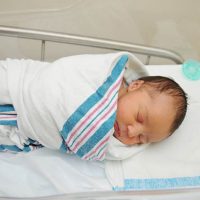 newborn baby wrapped into blanket