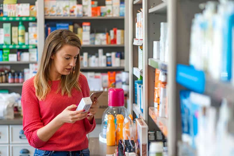 woman choosing product in pharmacy