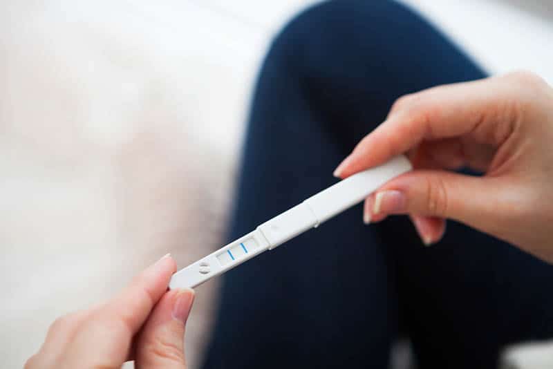 woman holding pregnancy test in hands