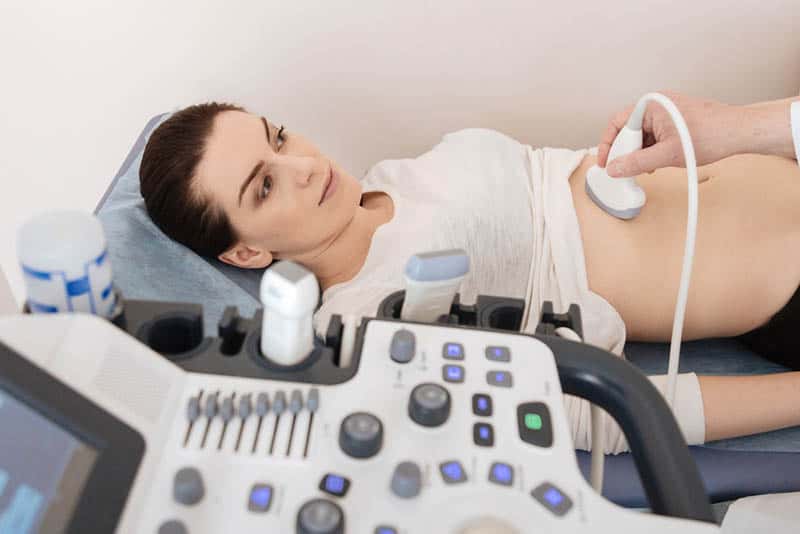 worried young woman thinking about ultrasound results