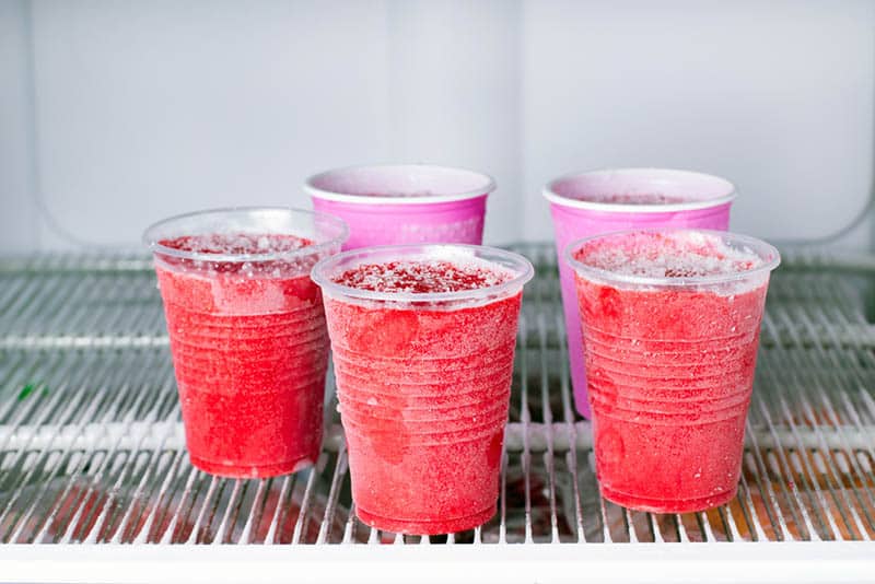 a few plastic glasses of smoothies in freezer