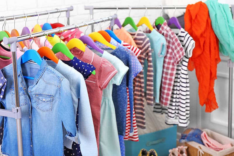 a lot of colorful clother for kids on hangers