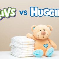 baby diapers with teddy bear on table