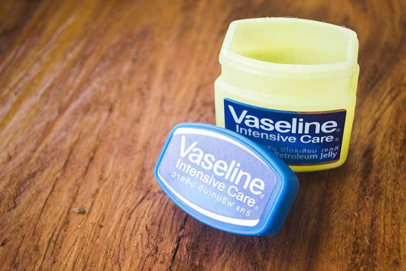 package of opened vaseline petroleum on the wooden table
