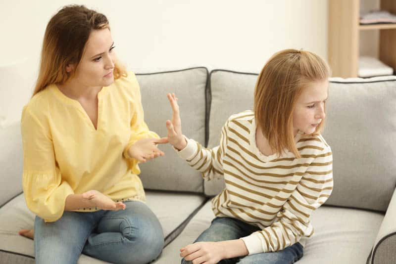 teenager girl refusing to talk with mother at home