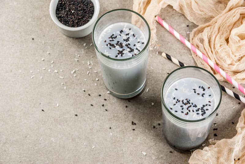 two glasses of fresh smoothies with sesame seeds