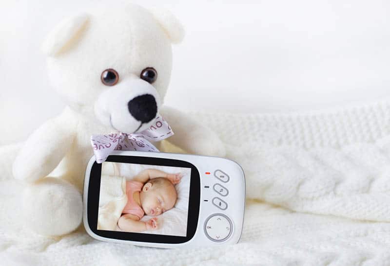 baby monitor for security of the baby surrounded by a teddy bear