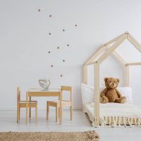 cute toddler bed with teddy bear in children's room