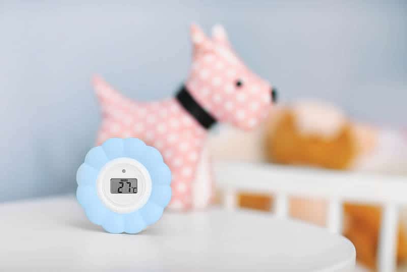 monitor of room temperature with toy on the table in the baby room