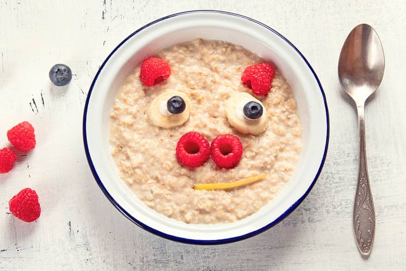Cute pig face shaped oatmeal with fruits for baby breakfast