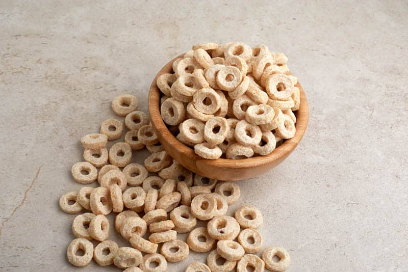 bowl full of honey nut cheerios cereals on the grey table