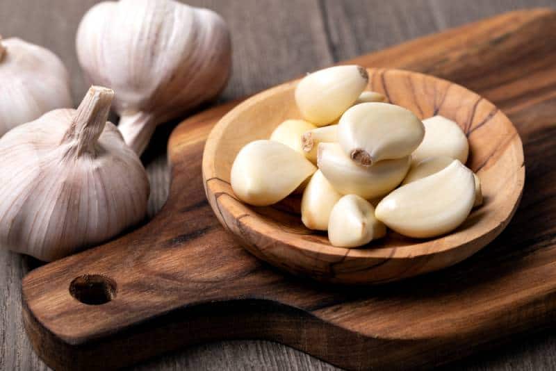 Garlic cloves in wooden bowl