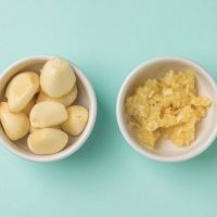 garlic cloves and mashed garlic in a bowl