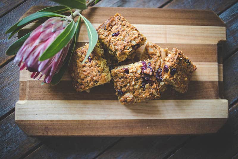 homemade lactation cookies on the wooden cutting board with a purple flower