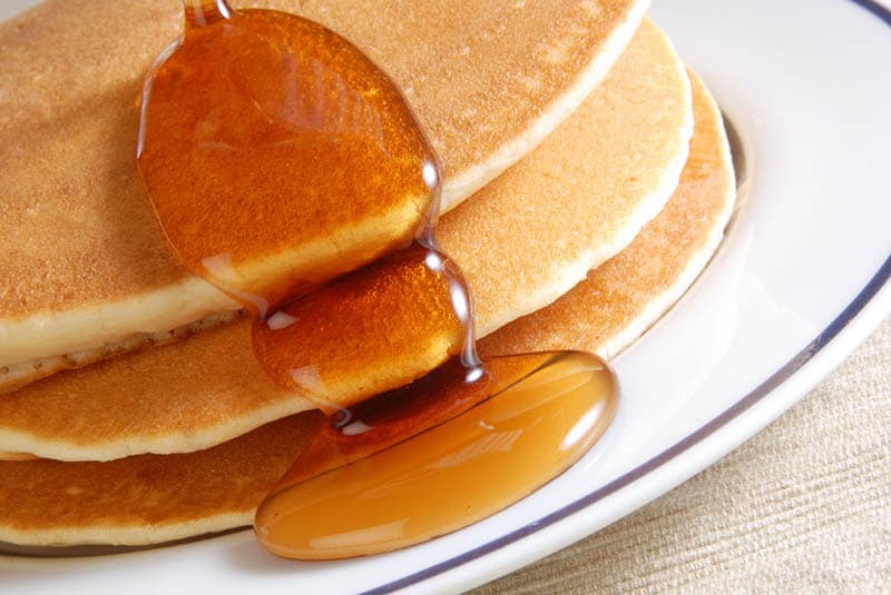 pancakes on the plate with maple syrup