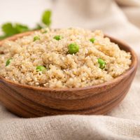 wooden bowl with quinoa and peas