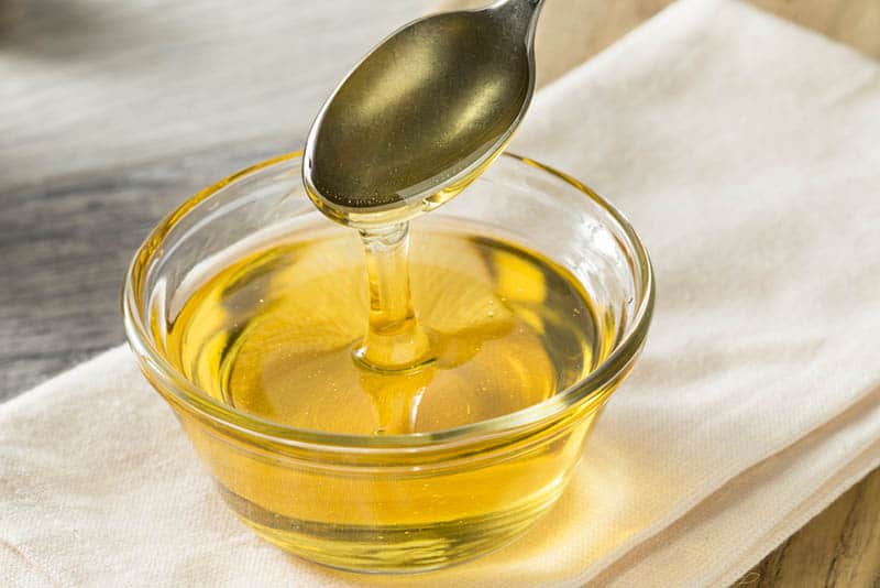 raw organic sweet light agave syrup in a bowl with spoon