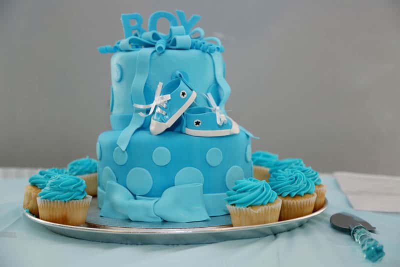 sweet blue baby boy shower cake on the table