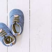 blue toddler shoes for flat feet on white wooden floor