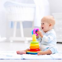 cute baby boy playing with educational toy