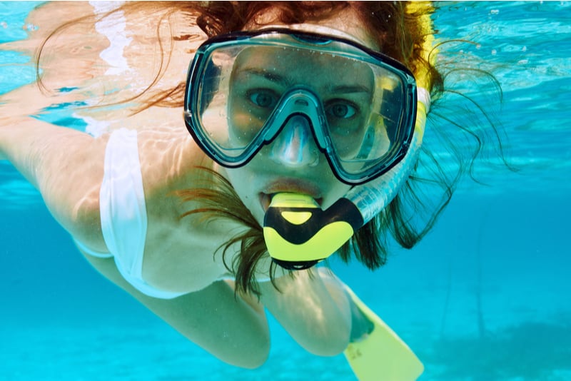 Woman snorkeling in clear water