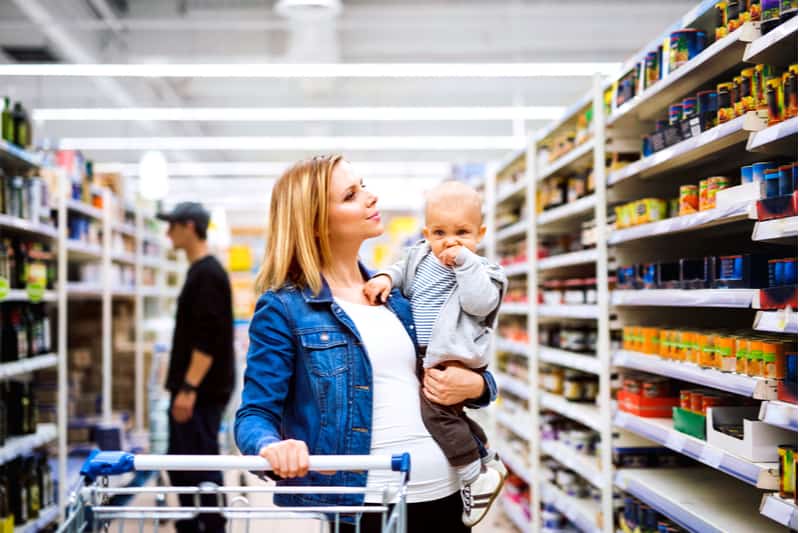 Young mother with her little baby boy at the supermarket