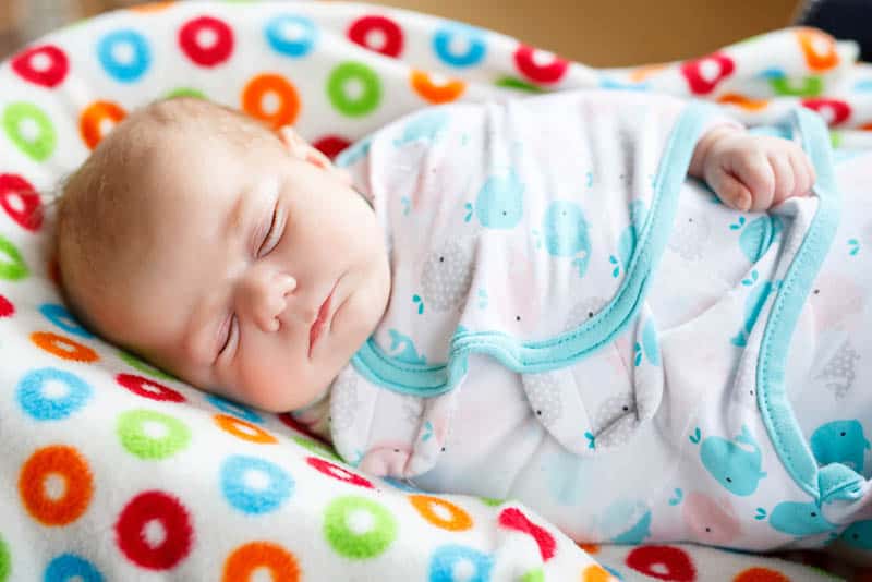 adorable swaddled baby sleeping tight