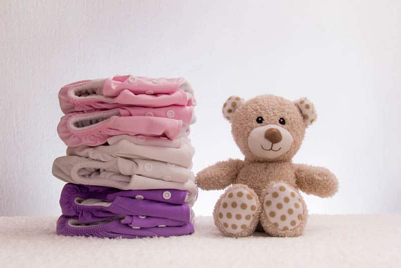 baby cloth panties with teddy bear toy on the floor
