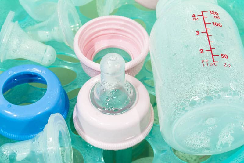 cleaning baby bottles in the water