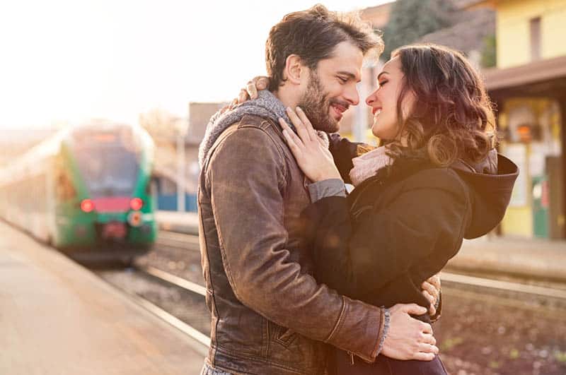 loving couple hugging on the railway station