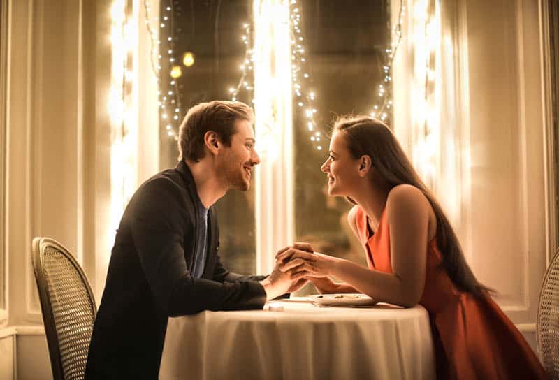 romantic couple having a dinner night in restaurant
