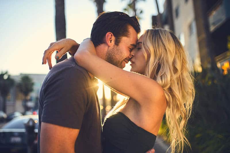 romantic couple kissing outdoor on sunset