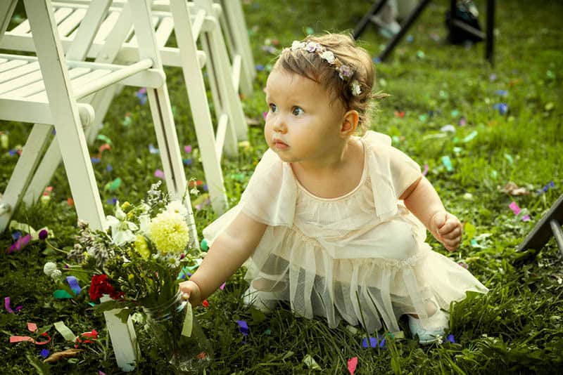 Cute little girl on a family wedding with flowers